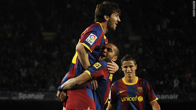 Dani Alves lifts Lionel Messi after setting up his Barcelona teammate for a record 50th goal this season.