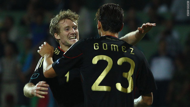 Germany's Andre Schurrle celebrates with Mario Gomez after scoring Germany's third against Azerbaijan.