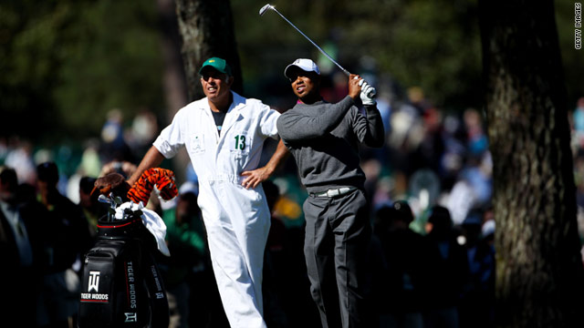 Caddy Steve Williams looks on as Tiger Woods hits a practice shot at Augusta National on Wednesday.