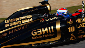 Vitaly Petrov displays a message of support for Lotus Renault teammate Robert Kubica during Jerez testing.