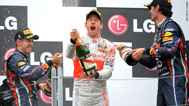Sebastian Vettel, left, showers Montreal winner Jenson Button with champagne along with third-placed Mark Webber, right.