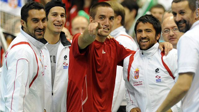 Viktor Troicki, center, celebrates with his teammates after securing victory for Serbia in the first round of the Davis Cup.
