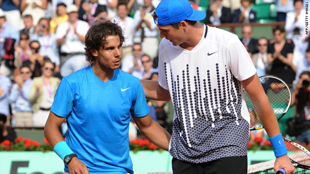 Rafael Nadal and American John Isner embrace after their five-set battle in the first round at the French Open on Tuesday.