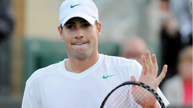 John Isner acknowledges the crowd at Wimbledon after beating Nicolas Mahut for the second year in a row.
