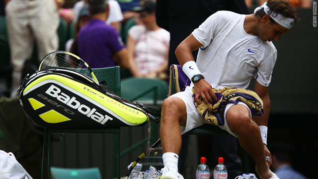 Rafael Nadal inspects his injured foot during his victory over Juan Martin del Potro on Monday.