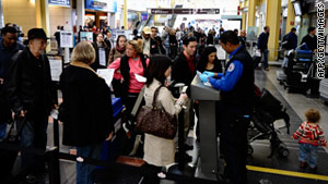 Travelers go through a security checkpoint at Reagan National Airport in Arlington, Virginia.