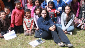 Lisa Napoli, surrounded by children in the village of Ura, has now visited Bhutan six times.