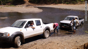 CNN's Nick Parker tugs a stranded pickup out of the water.