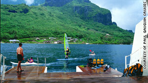 Deep green foliage, sparkling blue water and dark volcanic peaks comprise French Polynesia's scenery.