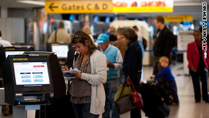 Passengers check in at New York's LaGuardia airport Monday after it resumed operations.