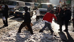 People walk on a snowy street in New York City's Chinatown on December 30.