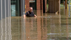 Michael Bunch wades on a flooded downtown sidewalk in Nashville, Tennessee, in May 2010.