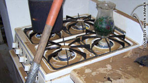 Formerly shiny white appliances were covered in dirt after a broken water main flooded Anita Kramer's basement kitchen.