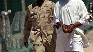 A U.S. military guard moves a detainee held at Guantanamo Bay, Cuba, in 2010.