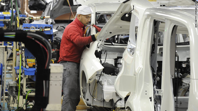 Nissan Motor workers install components into a Leaf electric vehicle on the assembly line of a plant in Yokosuka, Japan.