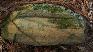 A large, flat rock marks the grave of Lewis Dickson.