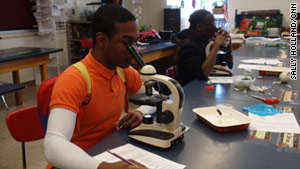 Student Roger Smith Jr. draws what he sees through the microscope at Glenville High School in Cleveland.