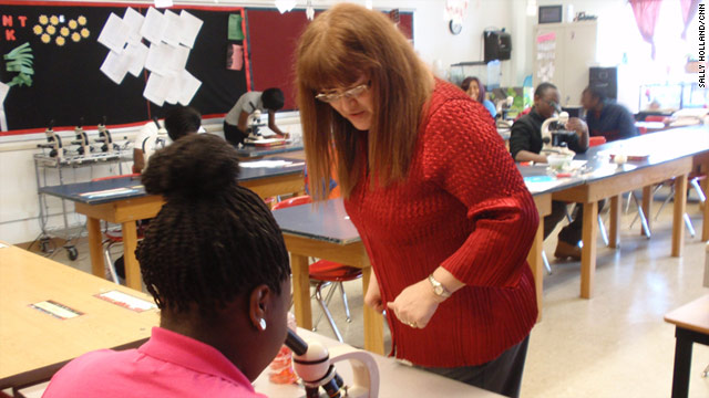 Biology teacher Rosalie Spano helps student Sabrina Ward at Cleveland's Glenville High School.