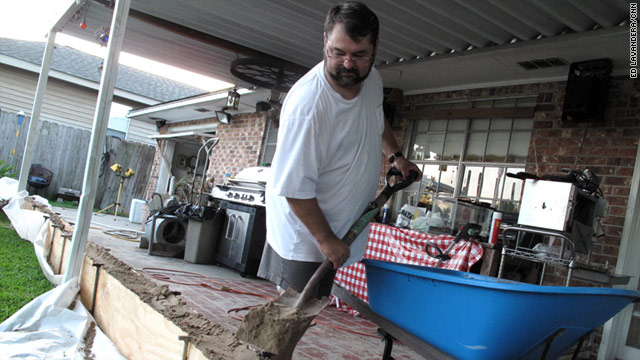 Calling it Cajun engineering, Gerald Gaudat builds a makeshift levee around his home in Stephenville, Louisiana.