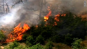 A wildfire burns in McLoud, Oklahoma, on Friday. Officials say more than 10 fires are burning across the state.