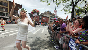 Gay rights supporters take part in New York's pride parade on Sunday, two days after the state legalized same-sex marriage.