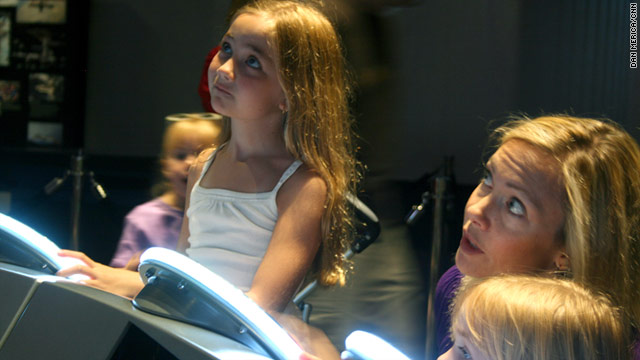Reagan Diesing, 9, watches the shuttle launch Friday with her mother and sister at the Air and Space Museum in Washington.