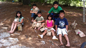 Kids gather after receiving lunches provided by Must Ministries, a nonprofit based in Cobb County, Georgia