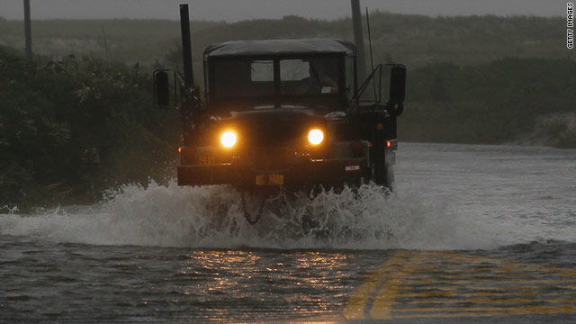 An Army vehicle drives down a flooded road in Southampton, New York, on Sunday.