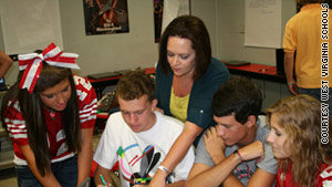 Poca High School teacher Sonjia Richardson, center, works with her students.