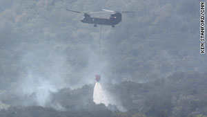 A helicopter helps fight a fire around Possum Kingdom Lake in Palo Pinto County, Texas, on Thursday.