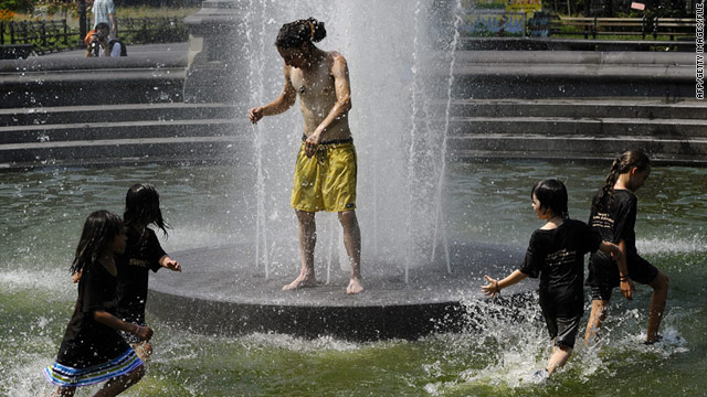 Children play in the Washington Square Park Fountain in New York City to escape the hot temperatures.