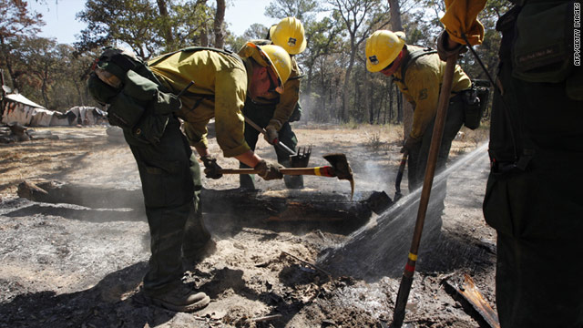 A firefighting crew from California clean up hot spots over the weekend in Bastrop, Texas, after the devastating wildfire.