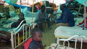 Refugees returning to the south make a temporary home at a camp at the Nile port of Kosti.