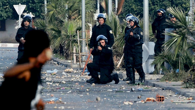 A member of the Tunisian security forces takes aim at a demonstrator on Monday in Regueb.