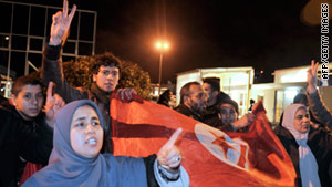 Tunisians celebrate at the airport after learning their president had left the country.
