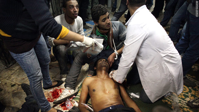Medics in a mosque attend to a man injured Saturday during clashes with police in Cairo, Egypt.