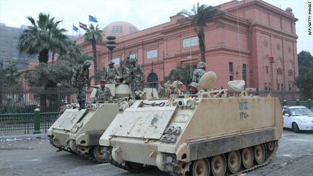 Egyptian soldiers stand guard in front of the National Museum in central Cairo after vandals ripped the heads off two mummies.