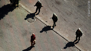 A man walks past soldiers on Monday in Cairo. Egypt's military has indicated it sympathizes with protesters.