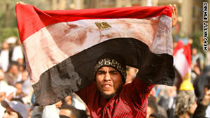 A protester brandishes a stained Egyptian flag in Cairo on Friday, February 4.