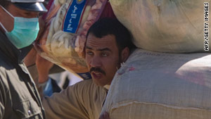 A man fleeing Libya crosses the border into Tunisia on Sunday.