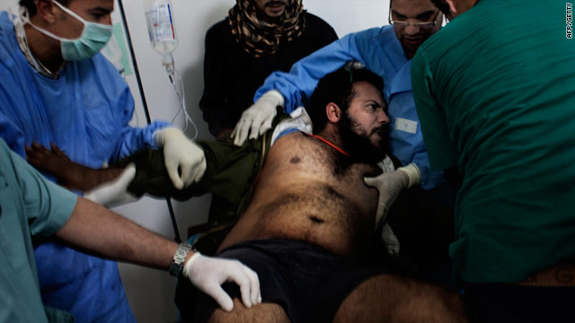 Doctors treat a wounded fighter in a Ras Lanuf hospital March 6. Medics in Misrata have complained of a lack of anesthesia.