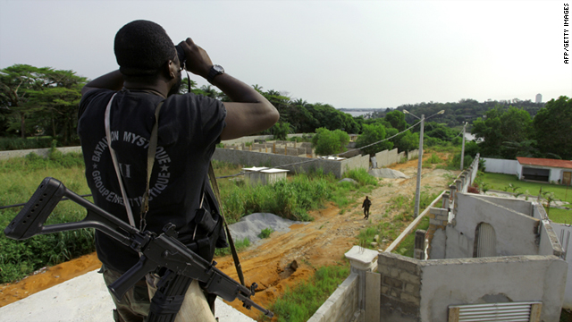A member of Ouattara forces looks through binoculars ahead of an attack on Laurent Gbagbo's Abidjan residence Wednesday.