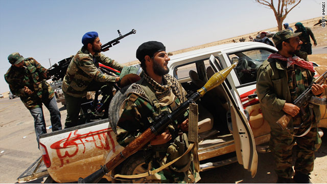 Rebels prepare to fight after hearing rumors of a Libyan army advance between Ajdabiya and al-Brega on Monday.