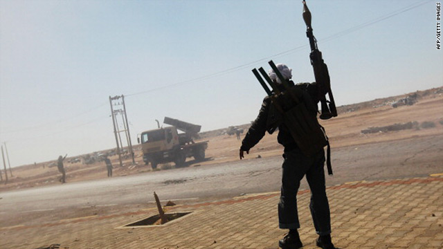 Rebel fighters celebrate after firing powerful rockets toward Libyan Army positions near Ajdabiyah April 11, 2011. 