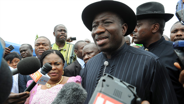 Nigerian President Goodluck Jonathan stands beside his wife, Patience, after voting on Saturday.
