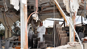 An investigator stands inside the Argana cafe days after a bombing last month.