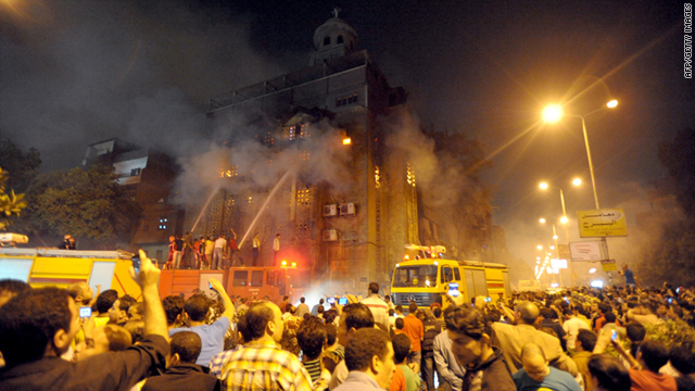 Egyptians gather as firefighters extinguish a blaze at a church following clashes at another church between Muslims and Christians in Cairo on Sunday.