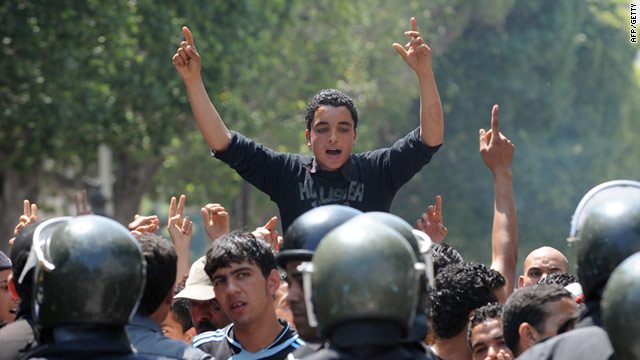 Tunisian riot police face protesters in Tunis on May 6 during a youth protest against the transitional government.