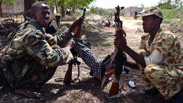 Somali government soldiers clean their weapons Thursday in Mogadishu, a city where a suicide attack killed two on Monday.