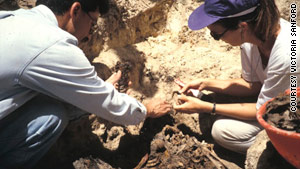 Victoria Sanford exhumes a mass grave in Guatemala in 1994 with Fernando Moscoso, founding president of the Guatemalan Forensic Anthropology Foundation.